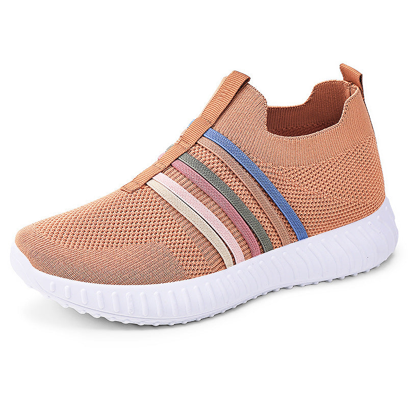 Pink slip-on sneaker with colorful stripes on a white background