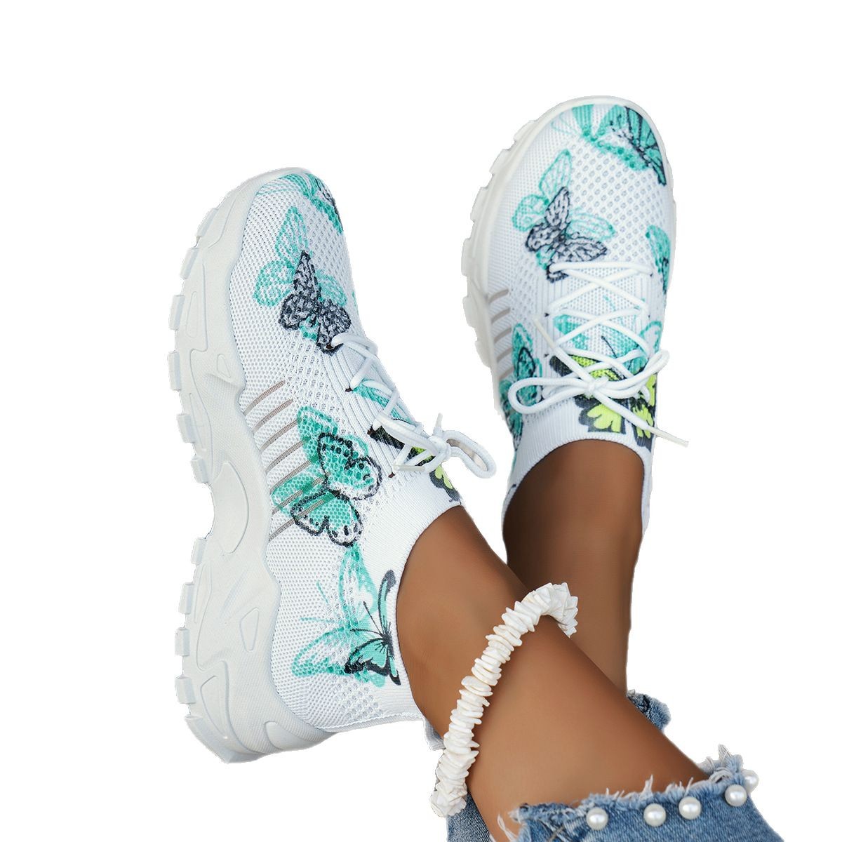 White sneakers with butterfly designs on a white background